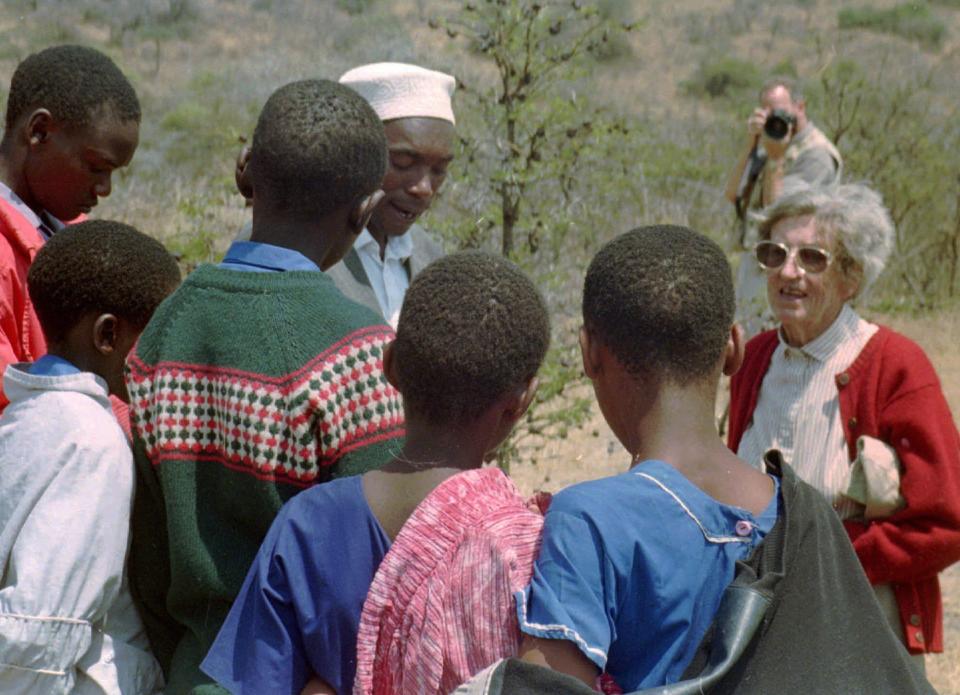 FILE -Archaeologist Mary Leakey speaks to Masai school children on Aug. 16, 1996 at Laetoli, northern Tanzania at the site of 3.6-million-year-old hominid footprints she identified 20 years ago. Prehistoric footprints that have puzzled scientists since the 1970s are getting a second look: Were they left by extinct animals or by human ancestors? When famed paleontologist Mary Leakey first uncovered the footprints in Tanzania 40 years ago, the evidence was ambiguous. (AP Photo/Susan Linnee, File)