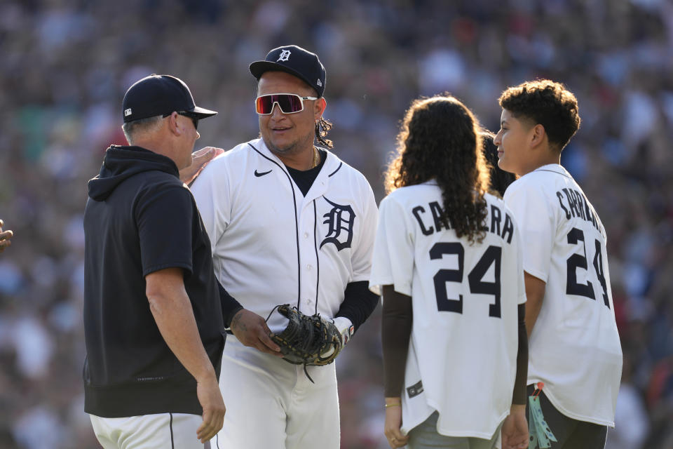 Detroit Tigers' Miguel Cabrera is taken out of the game by manager A.J. Hinch, left, and his children in the eighth inning of a baseball game against the Cleveland Guardians, Sunday, Oct. 1, 2023, in Detroit. Cabrera will retire after the game. (AP Photo/Paul Sancya)