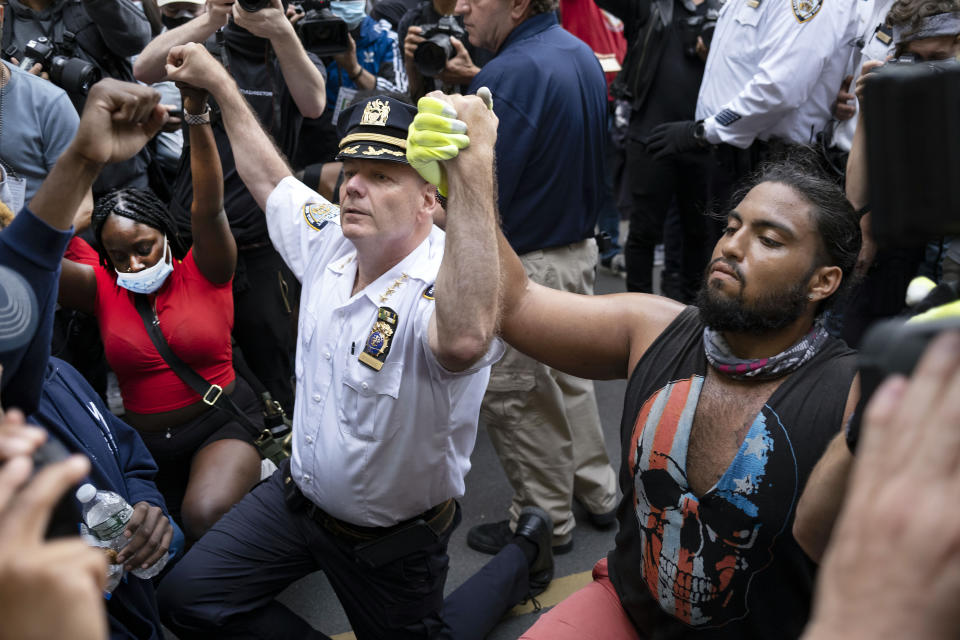 FILE — In this June 1, 202 file photo, Chief of Department of the New York City Police, Terence Monahan, kneels with activists as protesters paused while walking in New York. Monahan, who made headlines last year for kneeling with protesters while also being criticized for officers' forceful response, said Thursday, Feb. 25, 2021, that he is retiring after nearly four decades with the department. (AP Photo/Craig Ruttle, File)