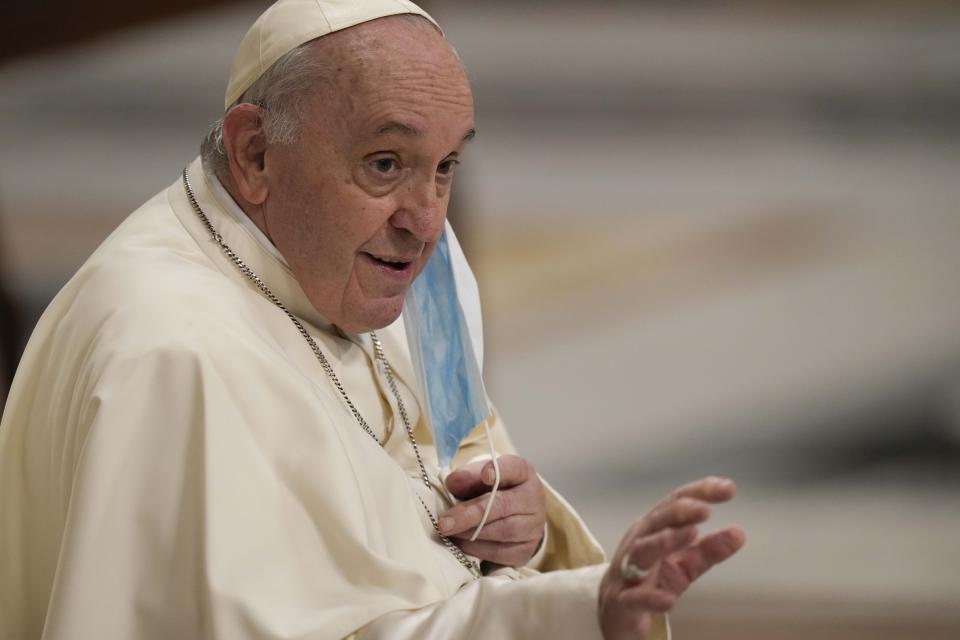 Pope Francis waves as he arrives to celebrate a new year's eve vespers Mass in St. Peter's Basilica at the Vatican, Friday, Dec. 31, 2021. (AP Photo/Andrew Medichini)