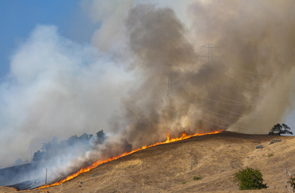 Power transmission tower is engulfed in back fire set by the firefighters in an effort to control the fire in Geyserville, California on October 26, 2019. 185,000 people are ordered to evacuate from Healdsburg, Windsor, Guerneville, Forestville, Occidental and several other communities as Kincade Fire grows to over 25,000 acres. (Photo by Yichuan Cao/NurPhoto via Getty Images)