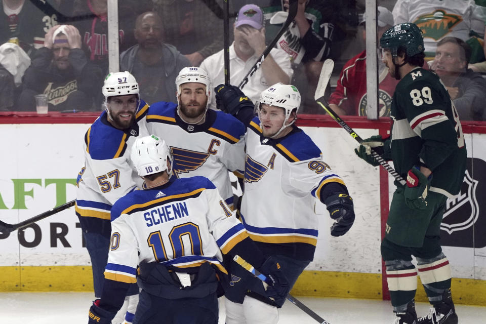 St. Louis Blues' Ryan O'Reilly, center. Is congratulated by teammates after scoring a goal off Minnesota Wild goalie Marc-Andre Fleury in the first period of Game 5 of an NHL hockey Stanley Cup first-round playoff series, Tuesday, May 10, 2022, in St. Paul, Minn. (AP Photo/Jim Mone)