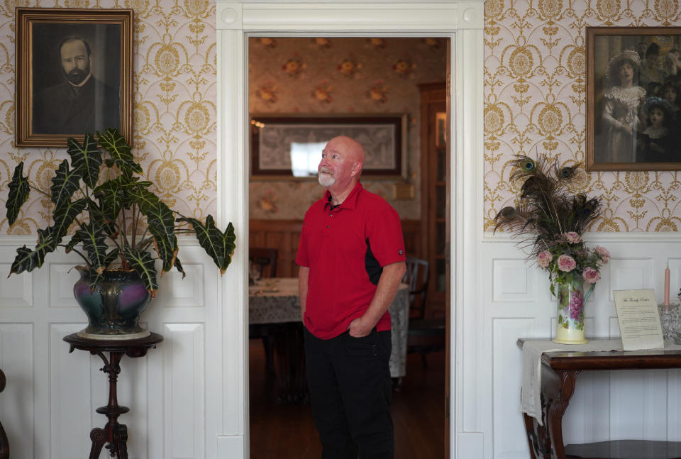 Mike McDowell, a board member for the Zion Historical Society and an associate pastor at Christ Community Church, stands for a portrait in the Historic Shiloh House, once owned by the town's founder, John Alexander Dowie. McDowell's great grandparents moved to Zion in 1905 from North Dakota because his great grandmother believed Dowie, a known faith healer, cured her whooping cough. (AP Photo/Jessie Wardarski)