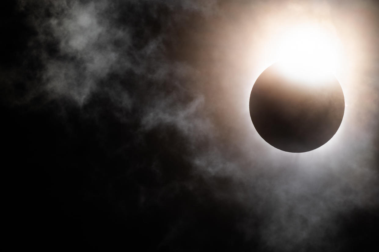  The moon begins its descent below the sun's horizon during a total solar eclipse on April 08, 2024 in Brady, Texas. 