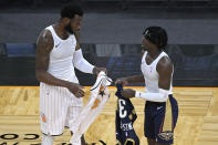 Orlando Magic forward Donta Hall, left, and New Orleans Pelicans guard Kira Lewis Jr. exchange jerseys after an NBA basketball game Thursday, April 22, 2021, in Orlando, Fla. (AP Photo/Phelan M. Ebenhack)