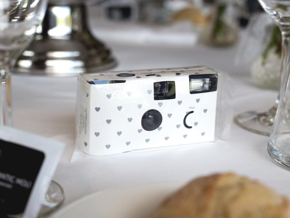 disposable camera sitting on a wedding table
