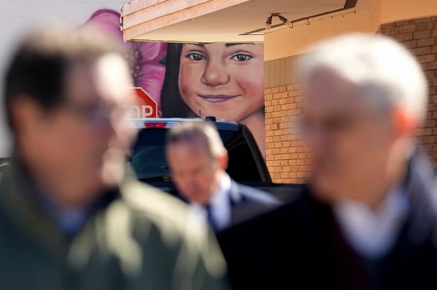 Artist Abel Ortiz, left, gives Attorney General Merrick Garland, right, a tour of murals of shooting victims, Wednesday, Jan. 17, 2024, in Uvalde, Texas. The Justice Department is planning this week to release findings of an investigation into the 2022 school shooting. (AP Photo/Eric Gay)