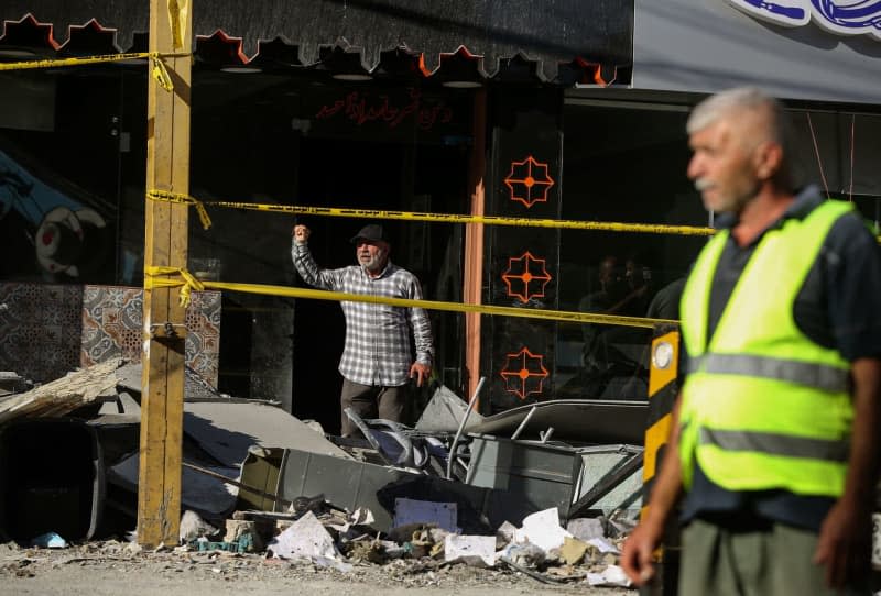 A Lebanese stands at the entrance of his shop that was damaged when Israel attacked a building in Beirut’s southern suburb. The attack targeted a top pro-Iranian Hezbollah commander. Marwan Naamani/dpa