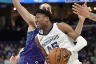 Memphis Grizzlies forward GG Jackson II (45) drives in front of Charlotte Hornets forward Aleksej Pokusevski during the first half of an NBA basketball game Wednesday, March 13, 2024, in Memphis, Tenn. (AP Photo/Brandon Dill)