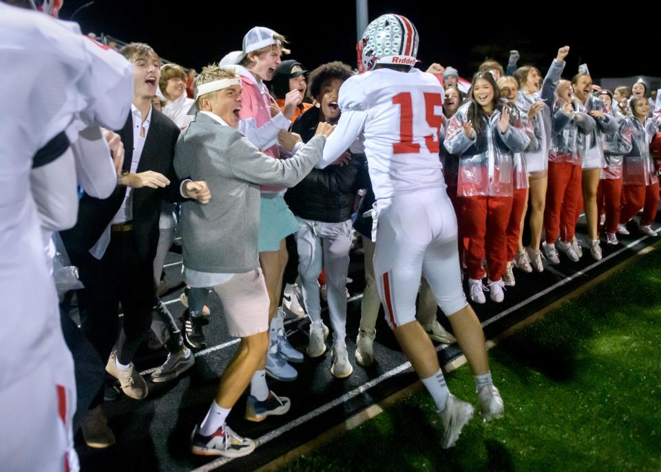 Morton's Brennen Rassi (15) and his teammates celebrate with their fans after their 10-6 victory over Dunlap in a Week 8 football game Friday, Oct. 13, 2023 at Dunlap High School.