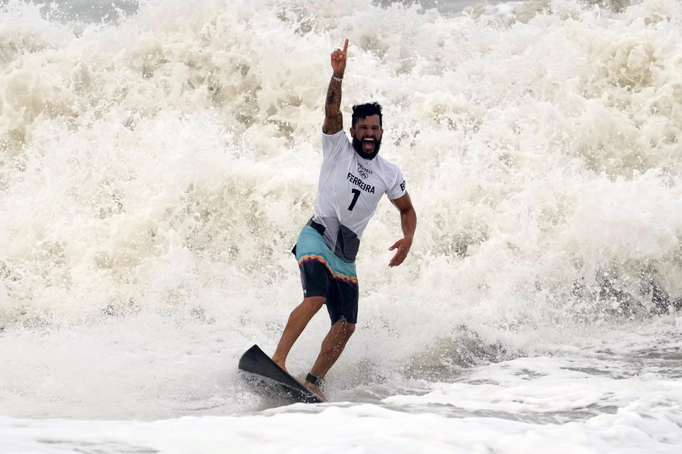 Brazil's Italo Ferreira celebrates wining the gold medal in the men's surfing competition at the 2020 Summer Olympics, Tuesday, July 27, 2021, at Tsurigasaki beach in Ichinomiya, Japan. (AP Photo/Francisco Seco)