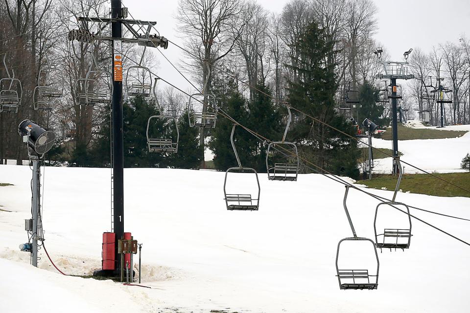 Manmade snow from the snow machines like the one near this chair lift at Snow Trails have gotten the slopes in condition for their opening on Friday.