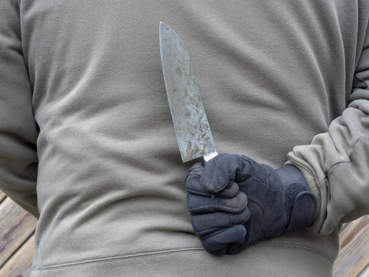 A man holds a knife: iStock/Getty