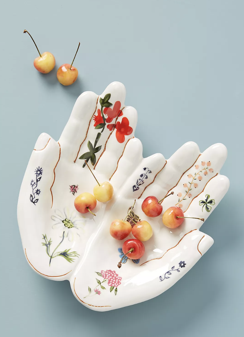 Nathalie Lete Titania Serving Platter of white hands on blue background (Photo via Anthropologie)