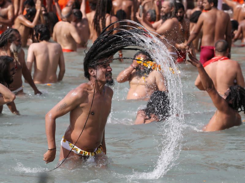 Naga Sadhus, or Hindu holy men, take a dip in the Ganges river during the first Shahi Snan at "Kumbh Mela", or the Pitcher Festival, in Haridwar