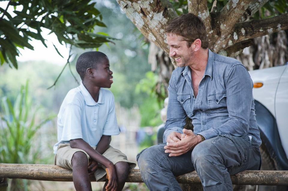 Gerard Butler in Liberia with Momolu (Chris Watt/PA)