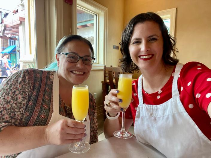 Author and friend holding mimosas.
