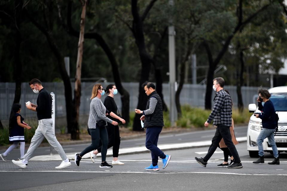 people walk towards a vaccination centre in Sydney