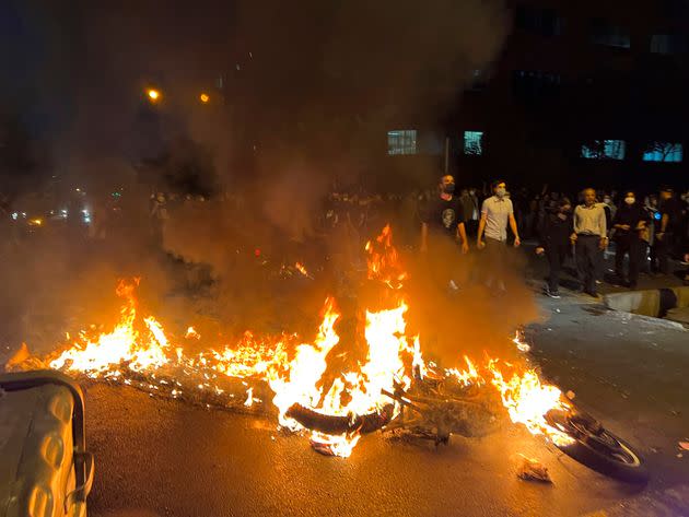 In this Monday, Sept. 19, photo taken by an individual not employed by The Associated Press and obtained by the AP outside Iran, a police motorcycle burns during a protest over the death of a young woman who had been detained for violating the country's conservative dress code, in downtown Tehran. (Photo: AP)