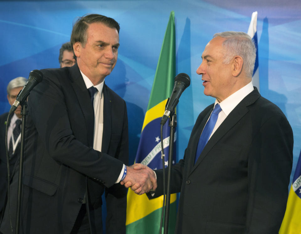 Israel's Prime Minister Benjamin Netanyahu, right, and Brazilian President Jair Bolsonaro, shake hands at Netanyahu's office in Jerusalem, Israel, Sunday March 31, 2019. Israel and Brazilian officials signed economic agreements Sunday, Bolsonaro is in Israel for a four-day visit. (Heidi Levine/Pool via AP)