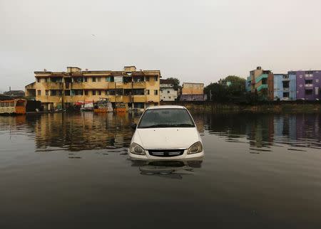 A car is seen in the flood waters at a neighbourhood in Chennai, December 4, 2015. REUTERS/Anindito Mukherjee