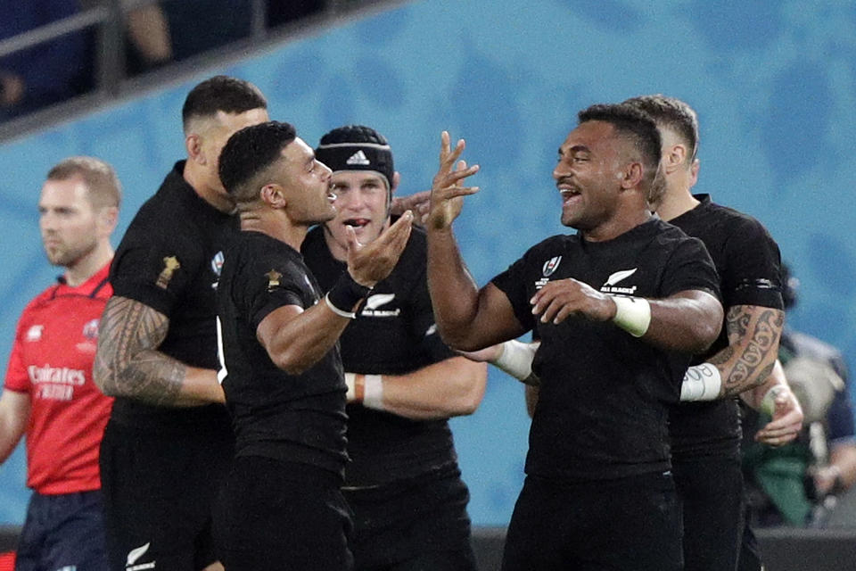 New Zealand' players celebrate a try during the Rugby World Cup quarterfinal match at Tokyo Stadium between New Zealand and Ireland in Tokyo, Japan, Saturday, Oct. 19, 2019. (AP Photo/Mark Baker)