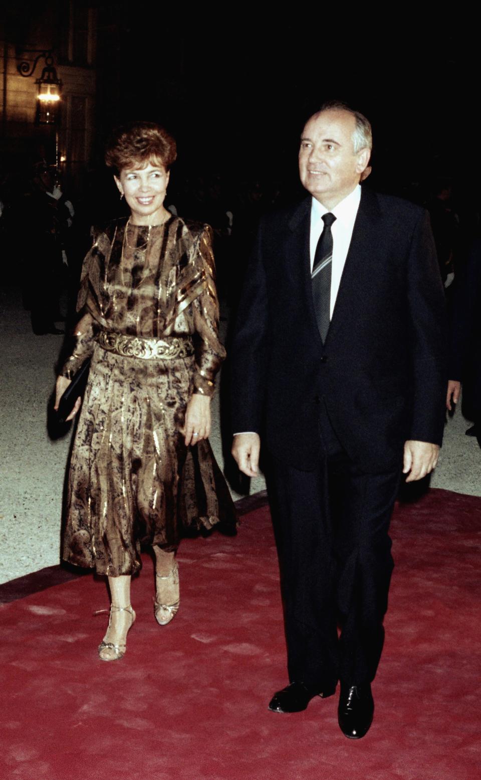 FILE - Soviet leader Mikhail Gorbachev and wife Raisa Gorbachev arrive at the Elysee palace in Paris on Wednesday, Oct. 2, 1985 to attend a gala dinner offered for them by French President Francois Mitterrand. When Mikhail Gorbachev is buried Saturday at Moscow's Novodevichy Cemetery, he will once again be next to his wife, Raisa, with whom he shared the world stage in a visibly close and loving marriage that was unprecedented for a Soviet leader. Gorbachev's very public devotion to his family broke the stuffy mold of previous Soviet leaders, just as his openness to political reform did. (AP Photo, File)