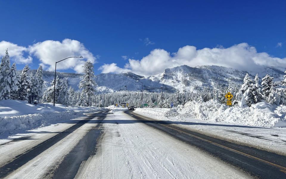 This Sunday, Jan. 1, 2023, photo released by Caltrans District 3, shows Sierra highway back open but chain controls remain in effect as crews clean up in South Lake Tahoe, Calif. California was drying out and digging out on New Year's Day after a powerful storm brought drenching rain or heavy snowfall to much of the state, snarling traffic and closing highways. (Caltrans District 3 via AP)