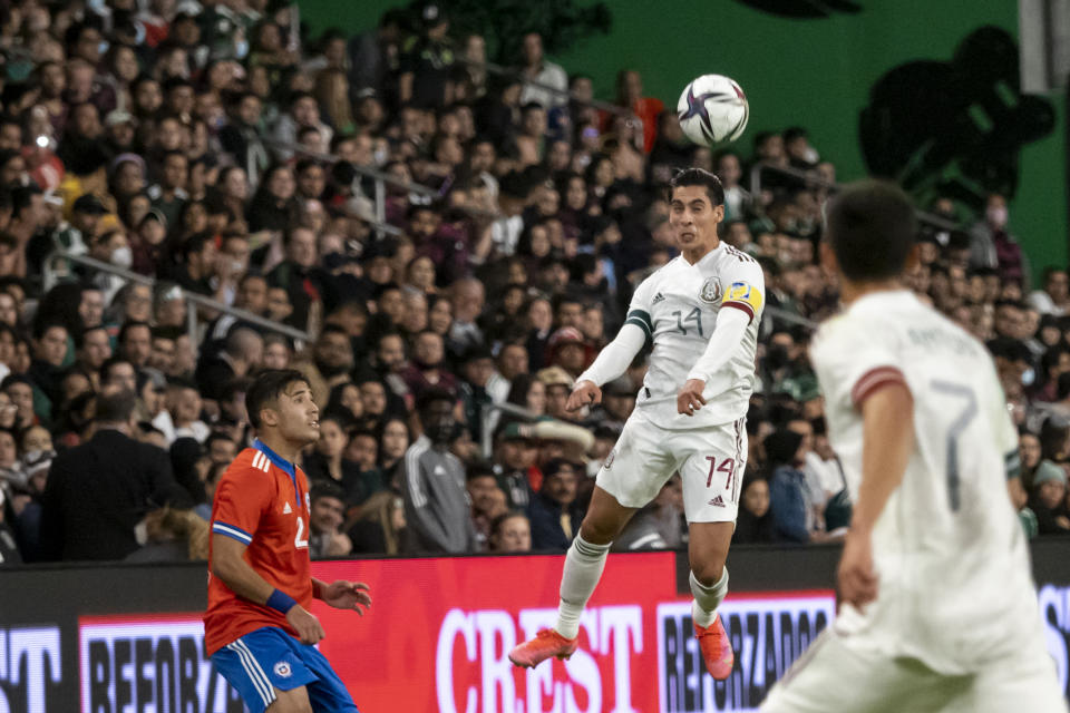 Mexico midfielder Mauro Alberto Lainez (14) heads the ball during the first half of the team's international friendly soccer match against Chile, Wednesday, Dec. 8, 2021, in Austin, Texas. (AP Photo/Michael Thomas)