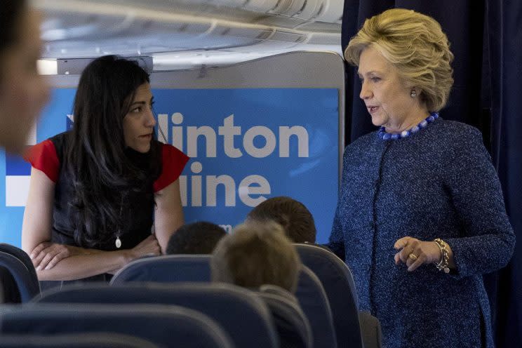 Hillary Clinton speaks with senior aide Huma Abedin aboard her campaign plane. (Photo: Andrew Harnik/AP)