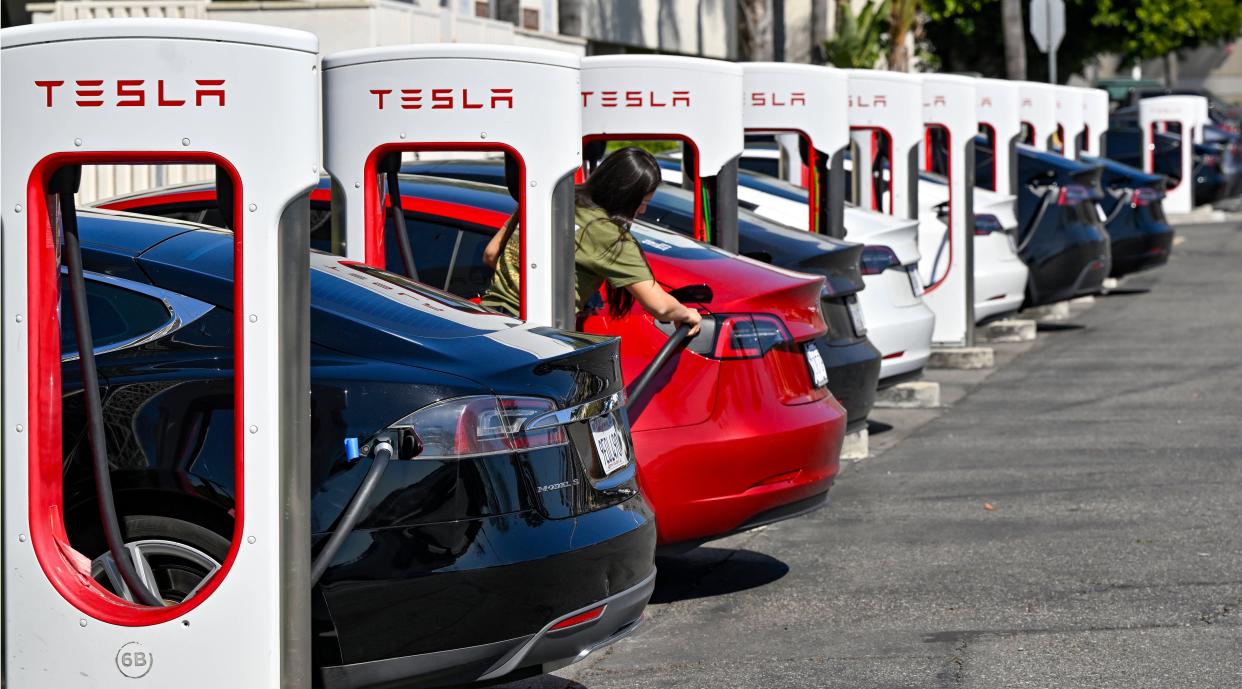 FILE - Drivers charge their Teslas in Santa Ana, Calif., on March 20, 2024. After reporting dismal first-quarter sales, Tesla is planning to lay off about a tenth of its workforce as it tries to cut costs, multiple media outlets reported Monday.(Jeff Gritchen/The Orange County Register via AP, File)