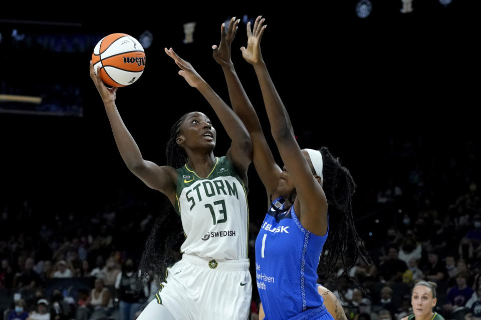 Seattle Storm center Ezi Magbegor (13) shoots over Connecticut Sun forward Beatrice Mompremier (1) during the first half of the Commissioner's Cup WNBA basketball game, Thursday, Aug. 12, 2021, in Phoenix. (AP Photo/Matt York)