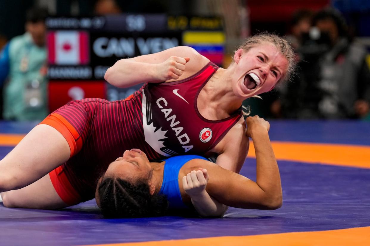 P.E.I. wrestler Hannah Taylor is shown pinning Ecuador's Luisa Valverde in the match that led to her entering the gold-medal round Thursday night.  (Candice Ward/COC - image credit)