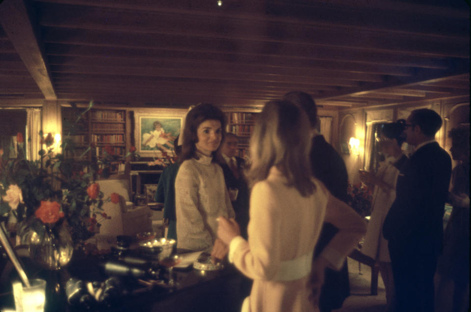 Jackie Kennedy Onassis talks to her guests at her wedding reception.