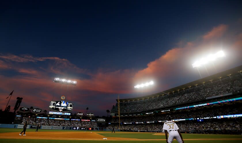 LOS ANGELES, CALIF. - JULY 19, 2022. The setting sun casts a rosy glow over Dodger Stadium.