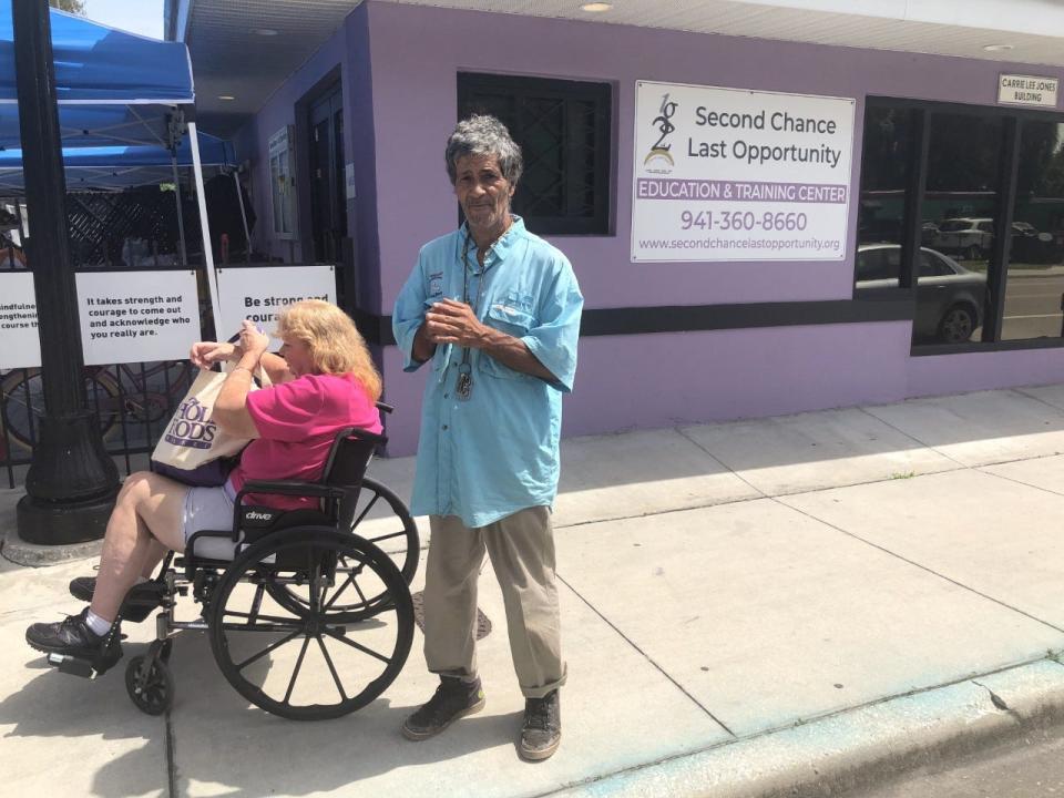 Brenda and Marcos Steiner wait in line at Second Chance Last Opportunity on Thursday.