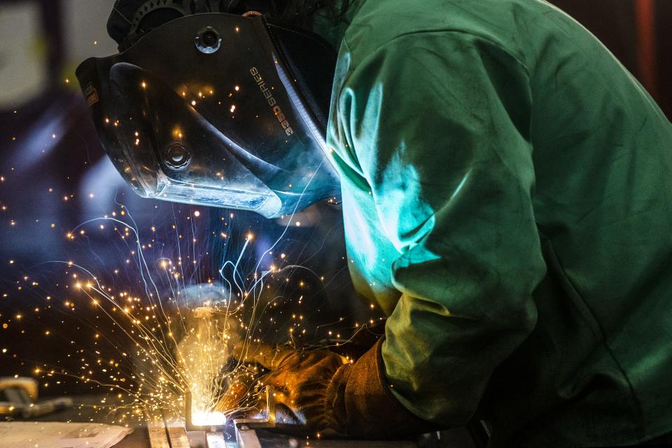 Teagan Hinrichs, a welder fabricator for Cemen Tech, does welding work on Thursday, Jan. 13, 2022, inside the concrete mixer manufacturing facility in Indianola.