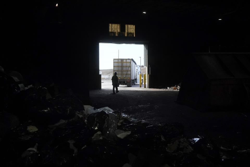 A truck backs into GreenWaste Zanker Resource Recovery Facility to load organic material in San Jose, Calif., Friday, Oct. 27, 2023. A pair of recent reports from the EPA put striking numbers to the problem of food waste: one-third of the food produced in the U.S. is never eaten. California began requiring every jurisdiction to provide organic waste collection services starting in 2022. (AP Photo/Jeff Chiu)