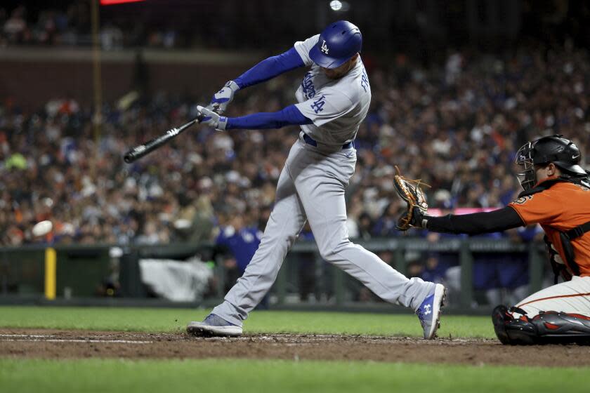 Los Angeles Dodgers' Freddie Freeman hits double in front of San Francisco Giants.