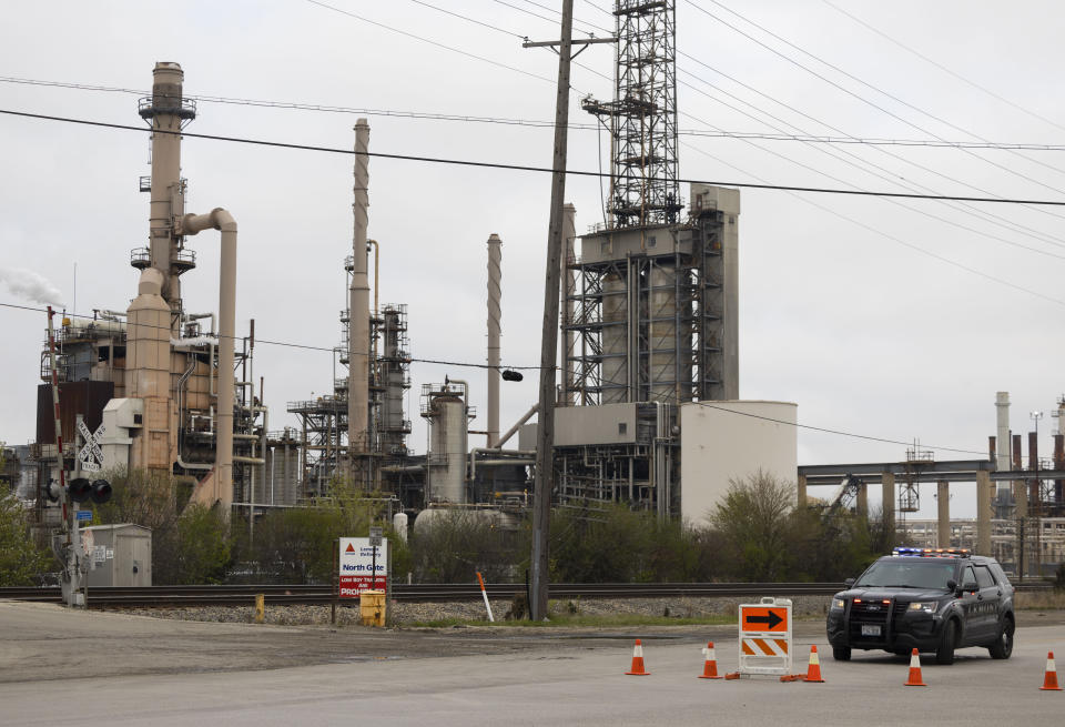 New Avenue is blocked off after an explosion at the Seneca Petroleum Company in Lemont, Ill., Tuesday, April 25, 2023. An explosion at the suburban Chicago petroleum plant killed one person and injured a second Tuesday morning, authorities said. (Eileen T. Meslar/Chicago Tribune via AP)