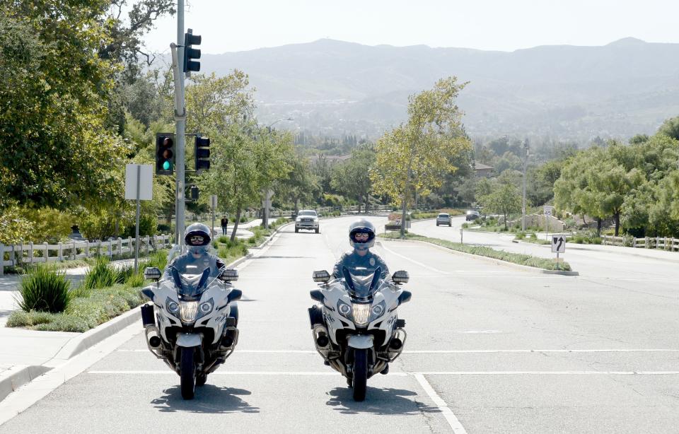 Simi Valley police officer Brett Suliga, left, a motorcycle trainee for the Simi Valley Police Department, and current motorcycle officer Eric Bowman cruise the streets of Simi Valley on Thursday.