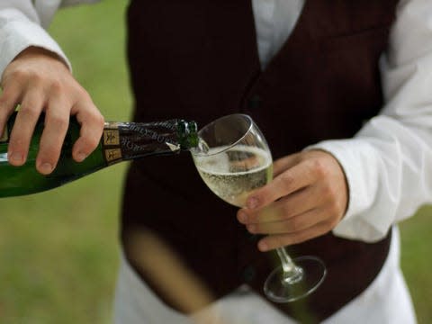 Waiter pouring a drink