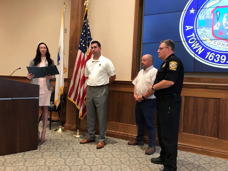 From Left, Taunton City Council President Kelly Dooner on June 20, 2023, presents a citation to Taunton Patrolman Dan Williams for saving the life of a 13-year old boy at a Taunton East Little League game. To the right are Parks & Rec Commissioner AJ Marshall and Police Chief Ed Walsh.