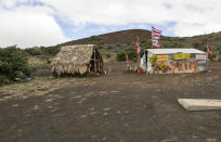 FILE - In this Aug. 31, 2015, file photo, the base camp for protesters of the Thirty Meter Telescope project occupies a site near the summit of Mauna Kea on Hawaii's Big Island. After years of protests and legal battles, Hawaii officials have announced that a massive telescope which will allow scientists to peer into the most distant reaches of our early universe will be built on a volcano that some consider sacred. (AP Photo/Caleb Jones, File)