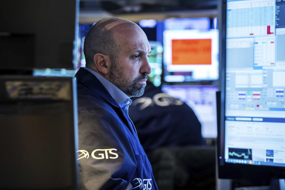 In this photo provided by the New York Stock Exchange, specialist James Denaro works at his post on the floor, Friday, March 4, 2022, in New York. Stocks around the world racked up more losses Friday, as even a gangbusters report on the U.S. jobs market can't pull Wall Street's focus off its worries about the war in Ukraine. (Courtney Crow/New York Stock Exchange via AP)