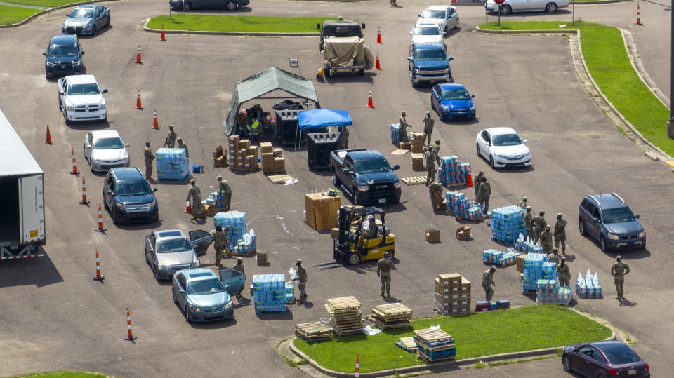 Members of the Mississippi National Guard distribute water and supplies to Jackson residents Friday Sep. 2, 2022, in Jackson, Miss. (AP Photo/Steve Helber)