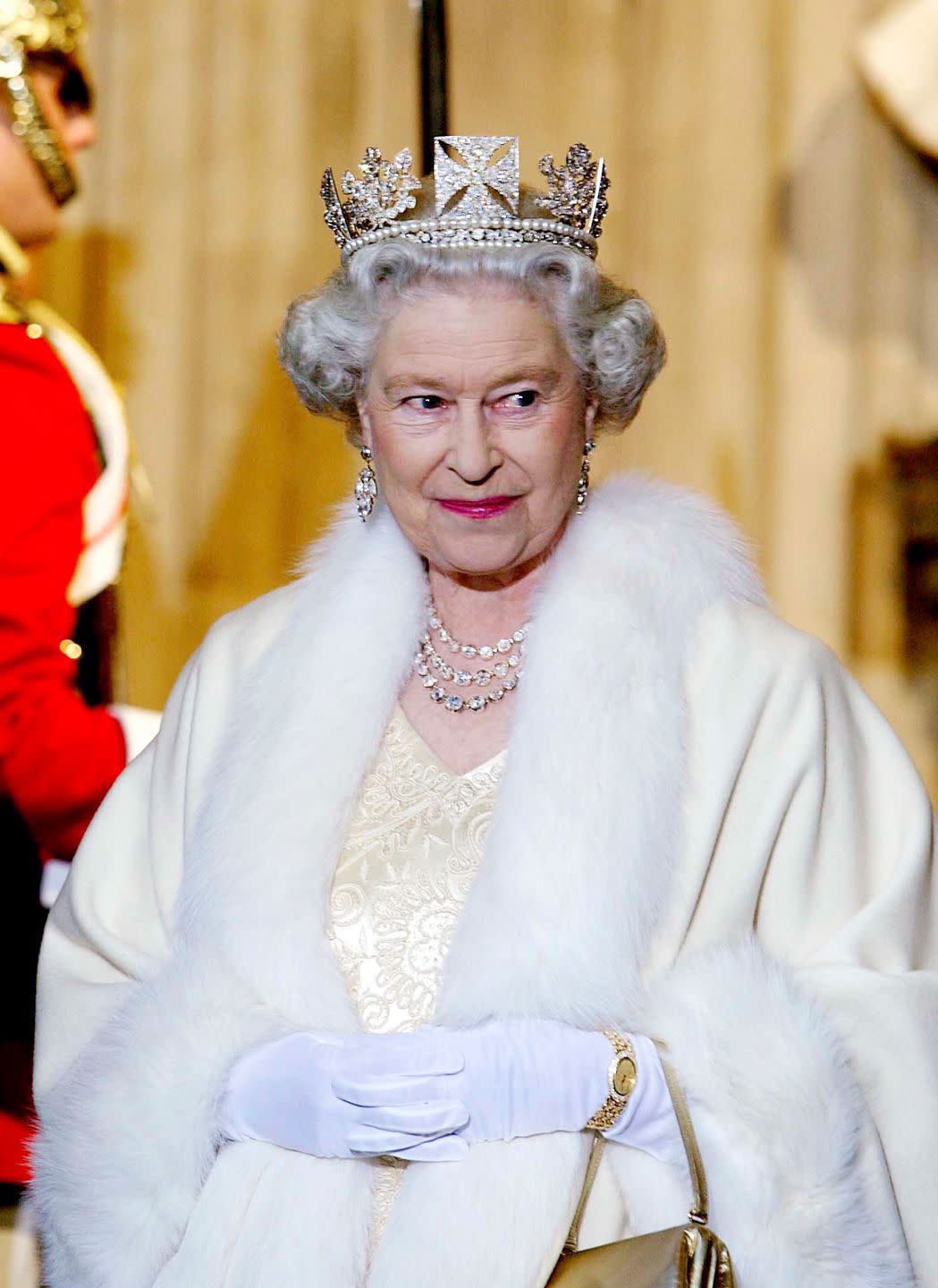 london, united kingdom november 13 queen elizabeth ii smiling as she arrives at the palace of westminster for the state opening of parliament the queen is wearing a diamond crown known as the state diadem made for the coronation of george lv she is wearing an embroidered cream satin dress covered with a fur trimmed robe photo by tim graham picture librarygetty images