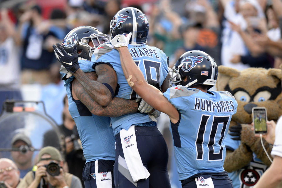 Tennessee Titans wide receiver Tajae Sharpe (19) celebrates with Adam Humphries (10) and Taylor Lewan, left, after Sharpe scored a touchdown against the Los Angeles Chargers in the second half of an NFL football game Sunday, Oct. 20, 2019, in Nashville, Tenn. (AP Photo/Mark Zaleski)