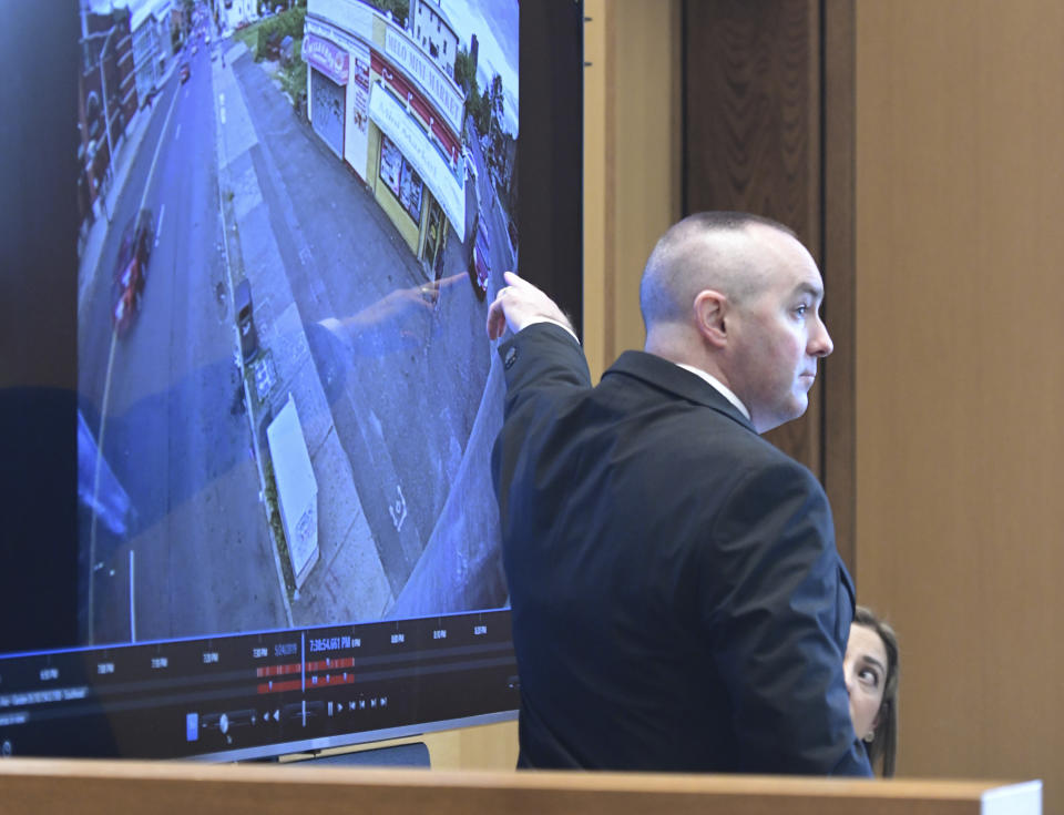 Connecticut State Police Sgt. Kevin Duggan points to the area where evidence was recovered on Albany Avenue in Hartford as he testifies on day eight of Michelle Troconis' criminal trial at Connecticut Superior Court in Stamford, Conn. Tuesday, Jan. 23, 2024. Troconis is on trial for charges related to the disappearance and death of New Canaan resident Jennifer Dulos. (Tyler Sizemore/Hearst Connecticut Media via AP)