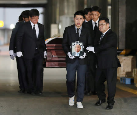 Family members mourn as the coffin carrying a body of one of the five South Korean climbers who were killed in the Himalayas is moved to a hearse, at Incheon International Airport in Incheon, South Korea, October 17, 2018. Yonhap via REUTERS